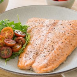 Baked Salmon On a Plate with Tomatoes and Salad