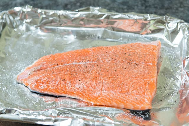 Seasoned Salmon on Foil Lined Tray Before Putting Salmon in Oven