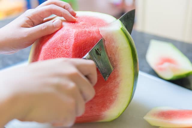 Cutting the Rind From Side of Watermelon